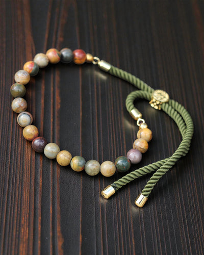 Moss Aura – Armband met Picasso-jaspis en 18K goud aan een groen koordje